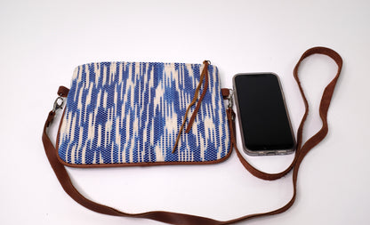 Crossbody Bag is composed of handwoven cotton fabric with light blue pattern and a detachable natural leather strap.