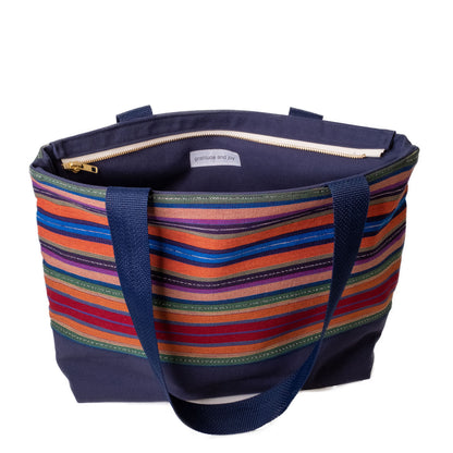 Handmade tote bag in blue featuring multicolored handwoven textiles from Guatemala.