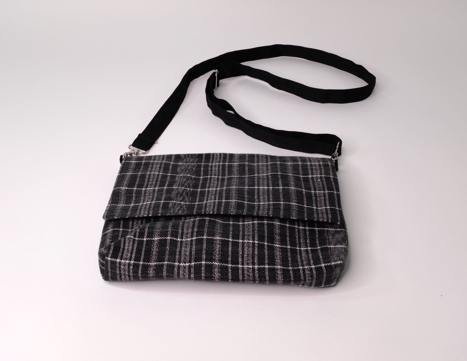 Crossbody bag constructed with carefully handwoven black ikat cotton textiles.