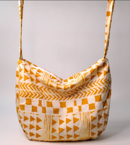 Large cross body bag with yellow arrow pattern.