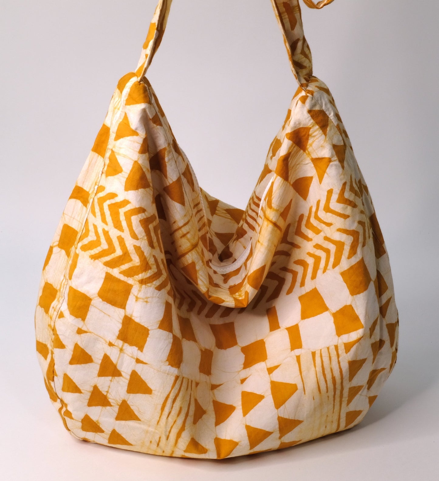 Large cross body bag with yellow arrow pattern.