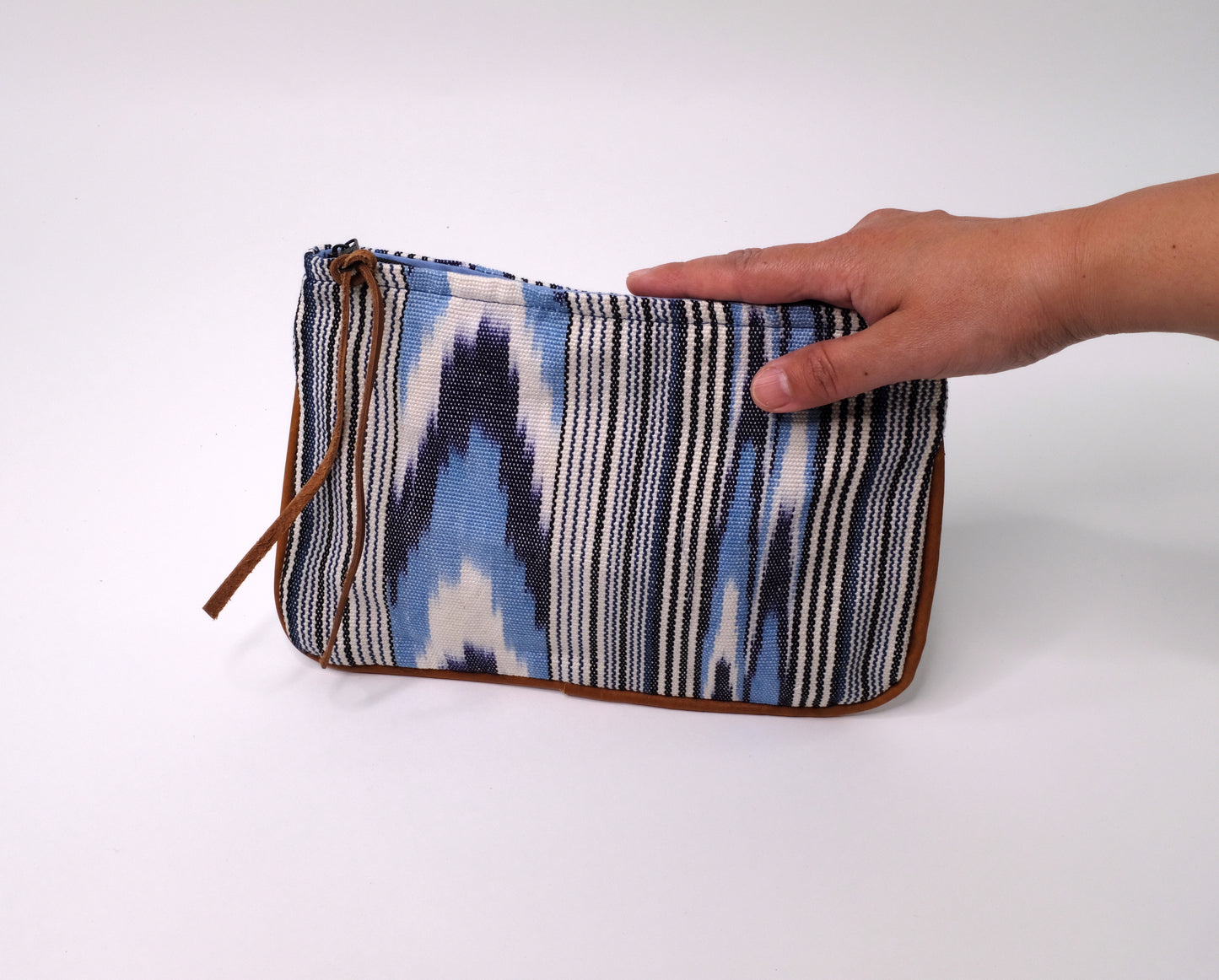 Handwoven Cosmetic Purse crafted from cotton and leather with light blue pattern.