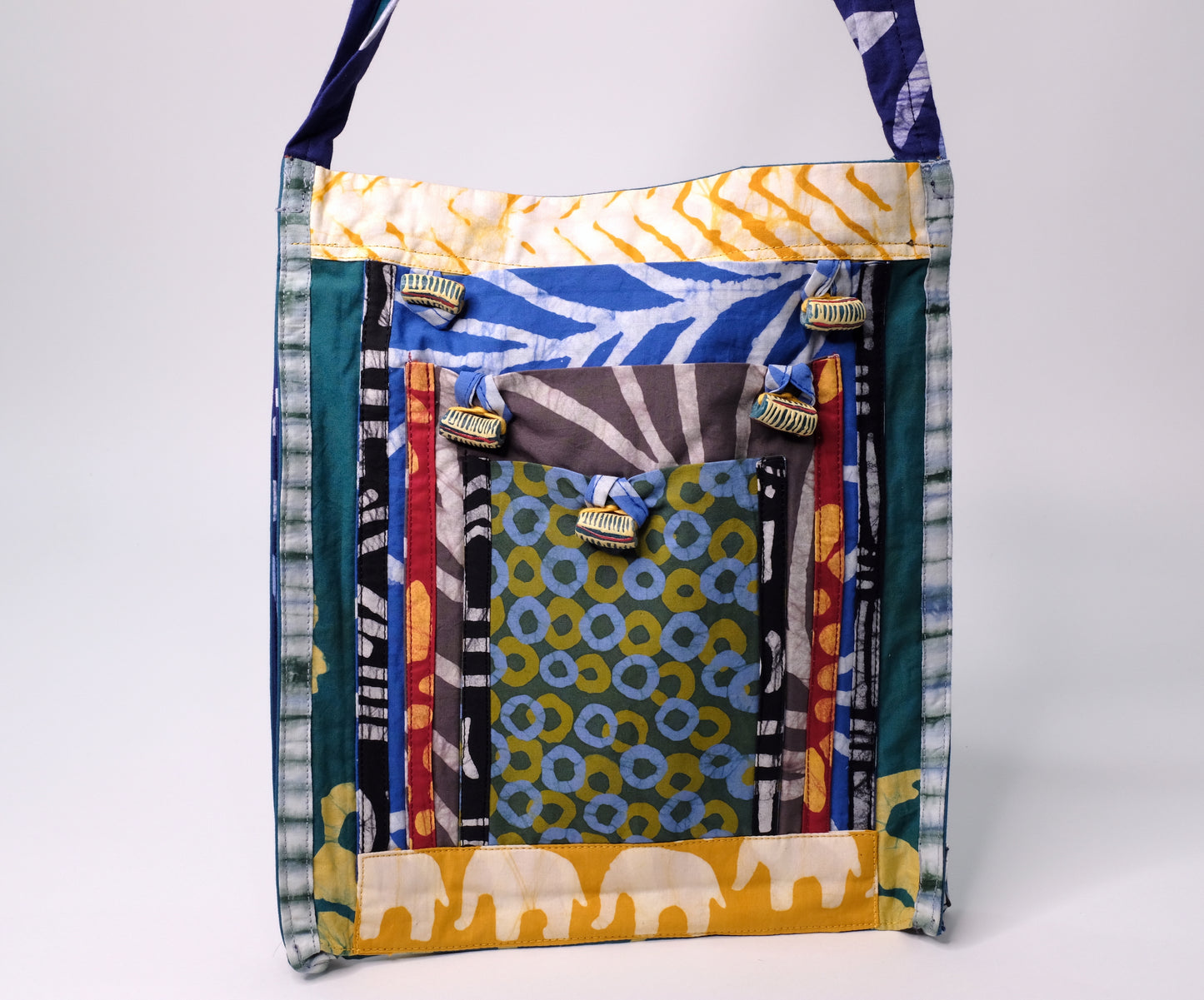 Colorful crossbody bag made from 100% recycled organic cotton and African beads.